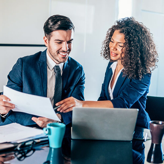 two-financial-advisors-looking-over-papers.jpg